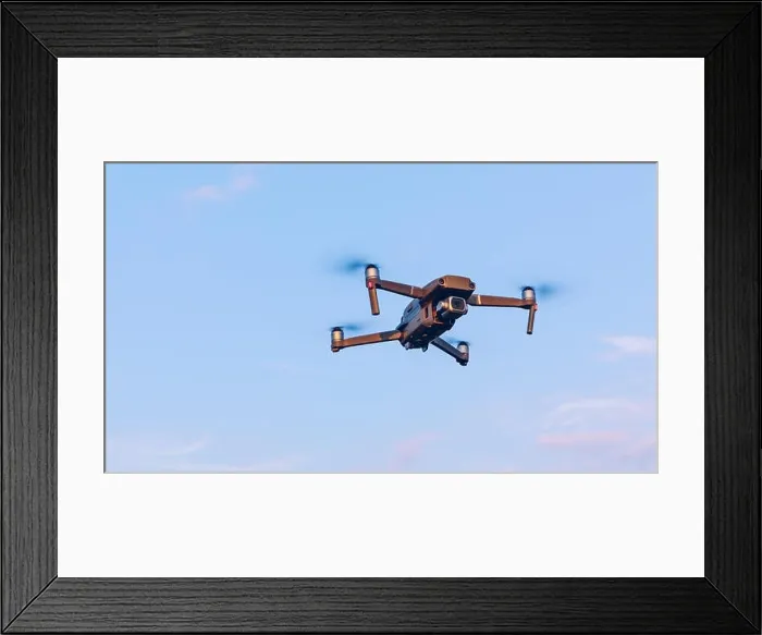 Framed Print : Drone flying over landscape. UAV drone copter flying with digital camera Framed Print : Drone flying over landscape. UAV drone copter flying with digital camera