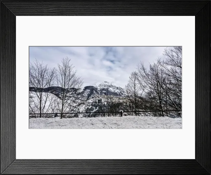 Framed Print : Aerial view of the beautiful snow-covered village of Opi with snow-capped mountains in the background