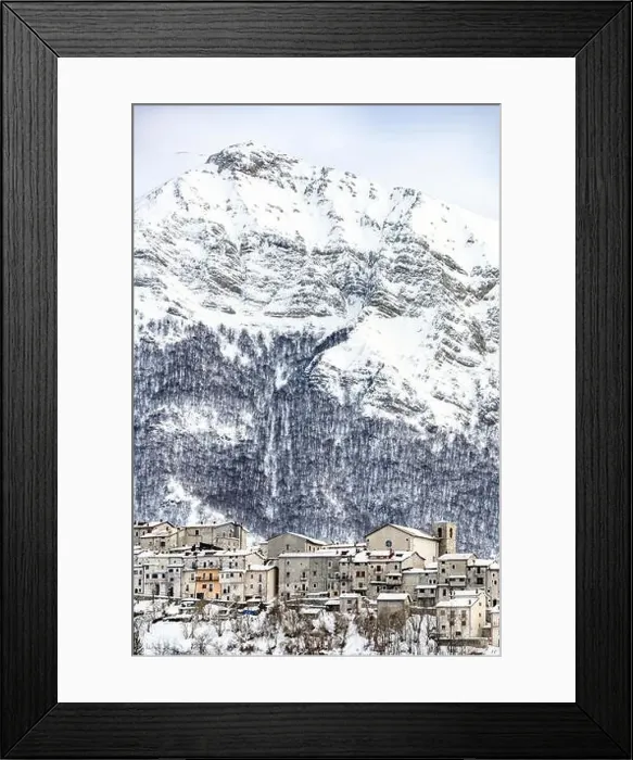 Framed Print : Aerial view of the beautiful snow-covered village of Opi with snow-capped mountains in the background Framed Print : Aerial view of the beautiful snow-covered village of Opi with snow-capped mountains in the background