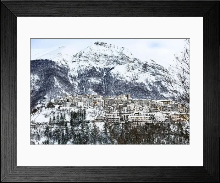 Framed Print : Aerial view of the beautiful snow-covered village of Opi with snow-capped mountains in the background Framed Print : Aerial view of the beautiful snow-covered village of Opi with snow-capped mountains in the background