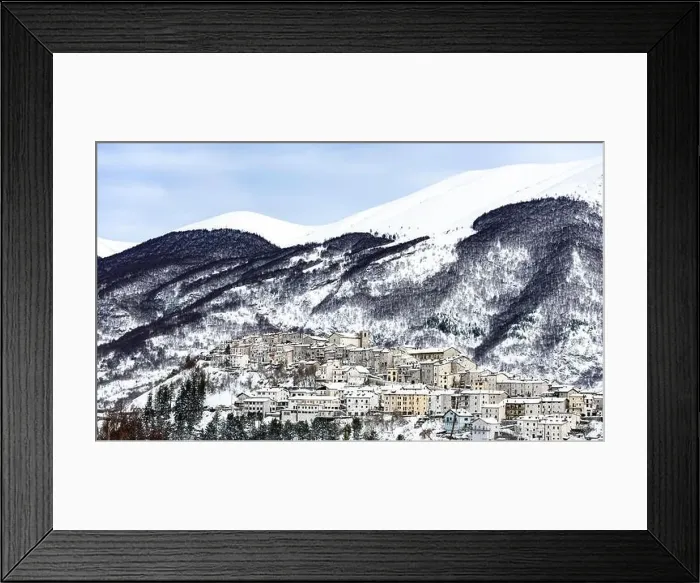 Framed Print : Aerial view of the beautiful snow-covered village of Opi with snow-capped mountains in the background Framed Print : Aerial view of the beautiful snow-covered village of Opi with snow-capped mountains in the background