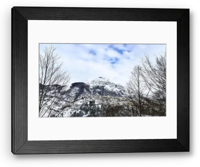 Framed Print : Aerial view of the beautiful snow-covered village of Opi with snow-capped mountains in the background