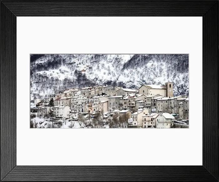 Framed Print : Aerial view of the beautiful snow-covered village of Opi with snow-capped mountains in the background Framed Print : Aerial view of the beautiful snow-covered village of Opi with snow-capped mountains in the background