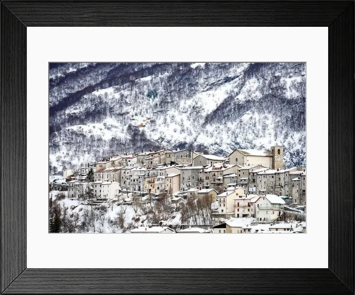 Framed Print : Aerial view of the beautiful snow-covered village of Opi with snow-capped mountains in the background