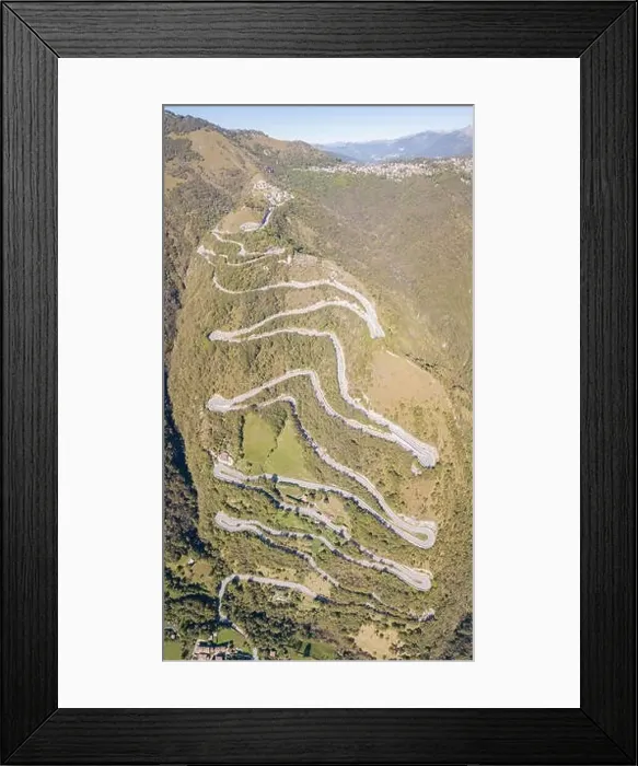 Framed Print : Up and down drone aerial view of the mountain road in Italy from the village of Nembro to Selvino
