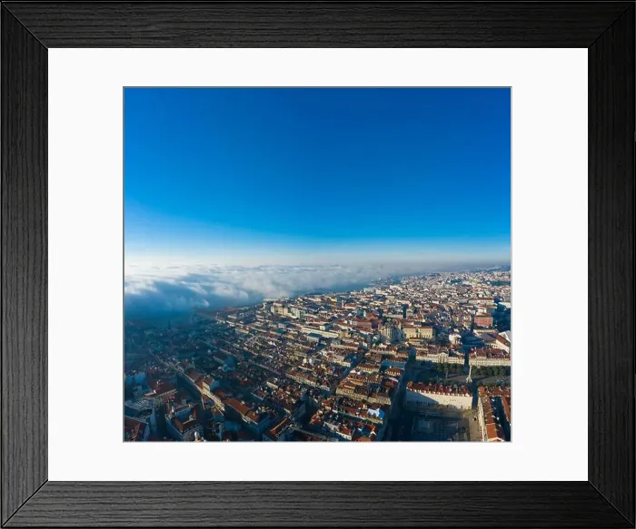 Framed Print : Aerial; panoramic drone view of foggy Lisbon morning; impending clouds over the ancient ginger roofs; blue skyline