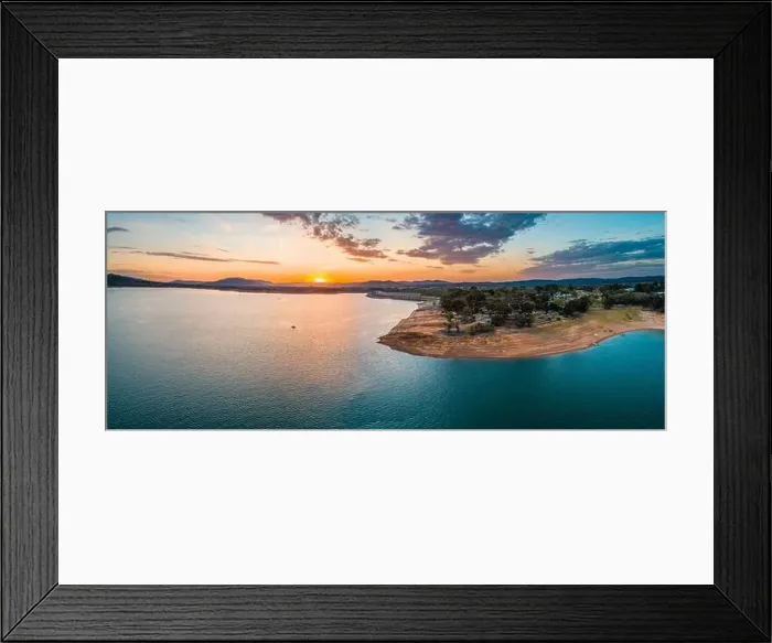 Framed Print : Wide aerial panorama of a tiny boat in big lake at sunset with copy space Framed Print : Wide aerial panorama of a tiny boat in big lake at sunset with copy space