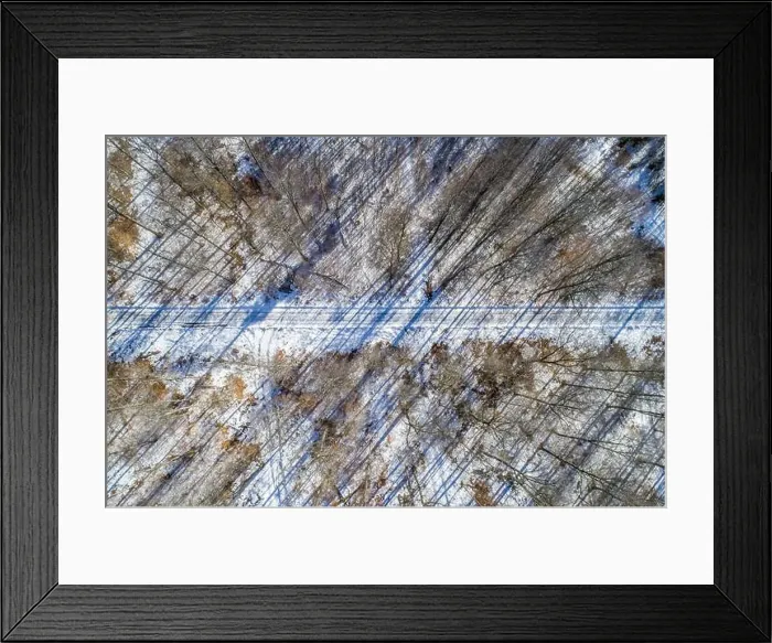 Framed Print : Straight road through winter forest - Aerial view, Germany Framed Print : Straight road through winter forest - Aerial view, Germany