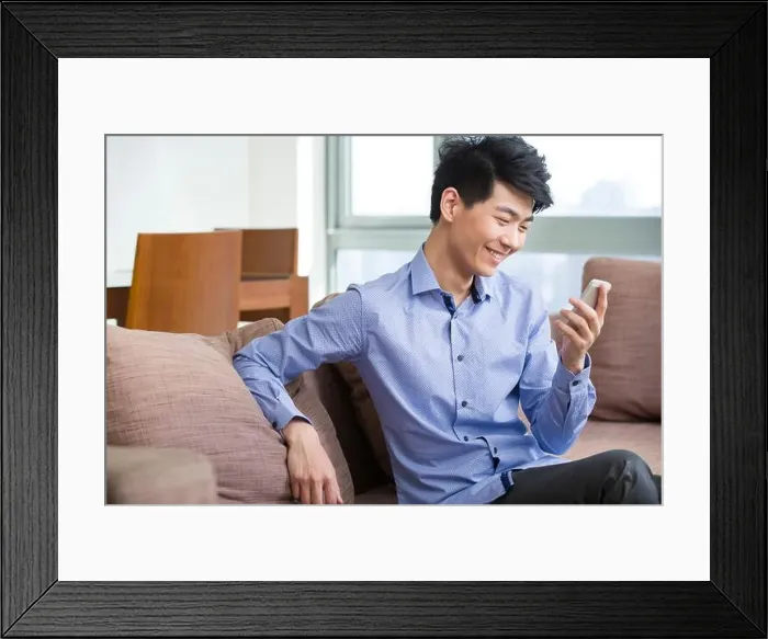 Framed Print : Young man using smart phone Framed Print : Young man using smart phone