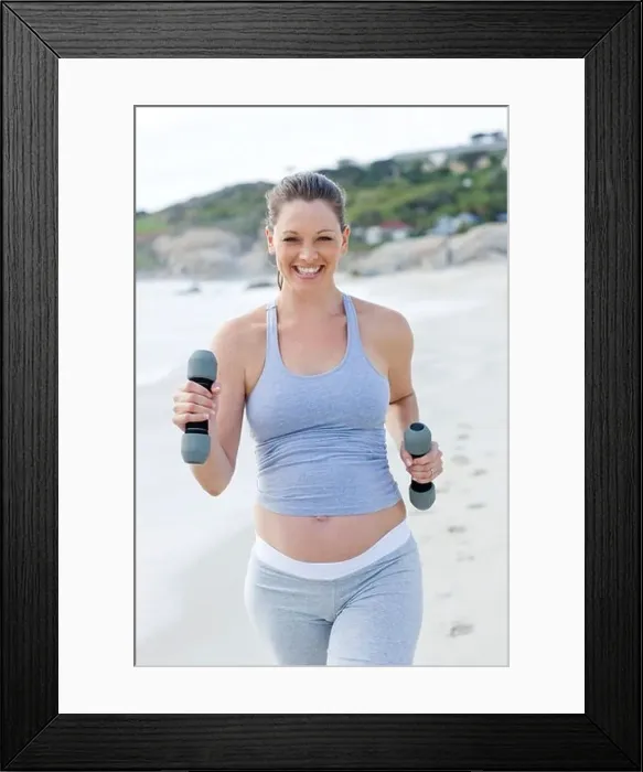 Framed Print : Pregnant woman exercising Framed Print : Pregnant woman exercising