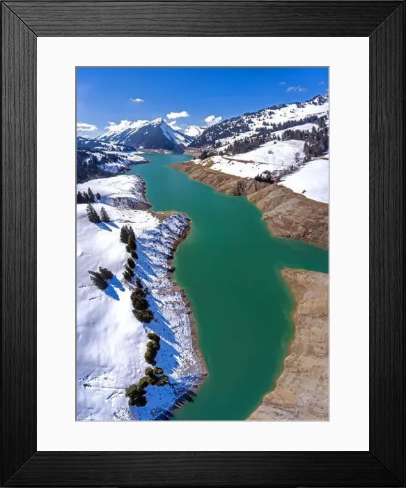 Framed Print : Lac de l'Hongrin is a reservoir in Vaud, Switzerland. Snowy mountain peaks surround the high alpine man made lake Framed Print : Lac de l'Hongrin is a reservoir in Vaud, Switzerland. Snowy mountain peaks surround the high alpine man made lake