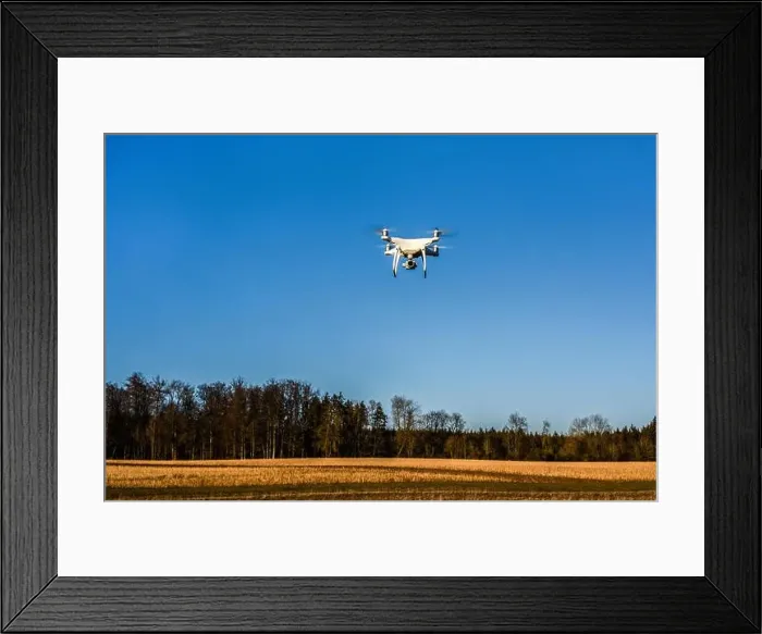 Framed Print : DJI Phantom 4 PRO quadcopter drone in the air flying over a field, Germany Framed Print : DJI Phantom 4 PRO quadcopter drone in the air flying over a field, Germany