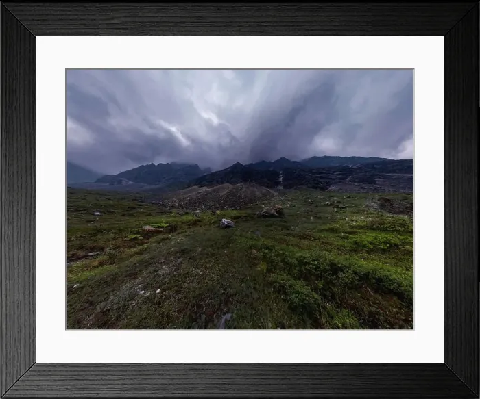 Framed Print : Black mountains in rain clouds, the foot covered with stones and green grass. Wide angle panorama Framed Print : Black mountains in rain clouds, the foot covered with stones and green grass. Wide angle panorama