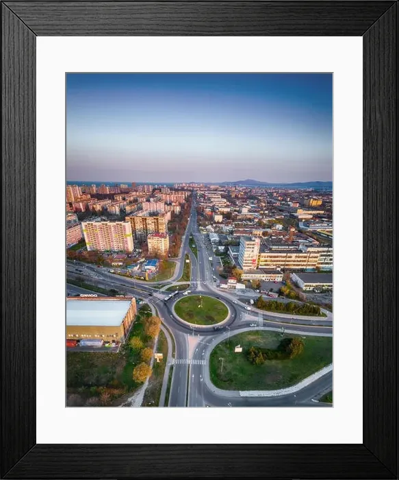 Framed Print : Panorama view of the road with a circular motion and a flower bed at sunset. Aerial photography