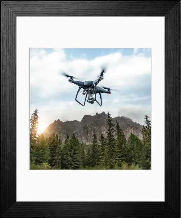 Framed Print : Modern drone flies in the mountains. Dark drone in the air against the backdrop of a mountain landscape Framed Print : Modern drone flies in the mountains. Dark drone in the air against the backdrop of a mountain landscape
