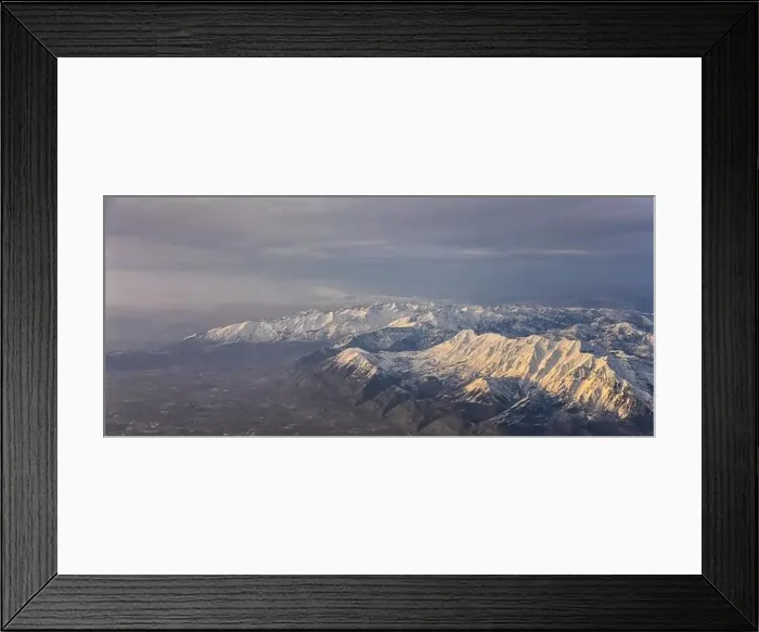 Framed Print : Aerial view from airplane of the Wasatch Front Rocky Mountain Range with snow capped peaks in winter including urban