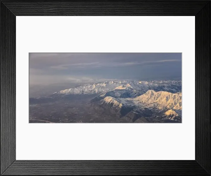 Framed Print : Aerial view from airplane of the Wasatch Front Rocky Mountain Range with snow capped peaks in winter including urban