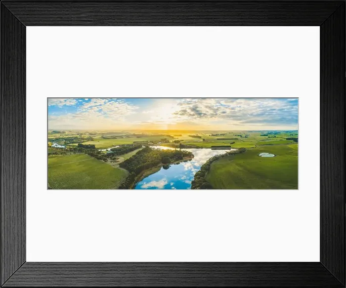 Framed Print : Sun setting over scenic Australian countryside grasslands and pastures with river passing through - aerial panorama Framed Print : Sun setting over scenic Australian countryside grasslands and pastures with river passing through - aerial panorama