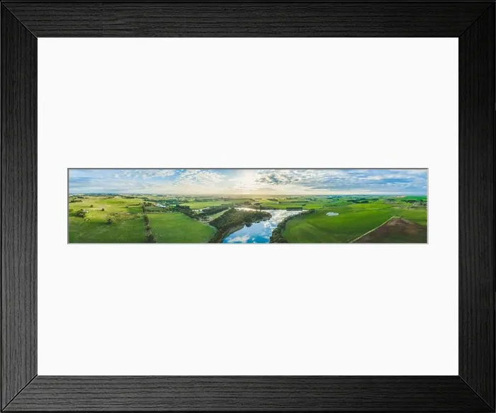 Framed Print : Wide aerial panorama of river flowing through grasslands, meadows, and pastures in Australia at sunset Framed Print : Wide aerial panorama of river flowing through grasslands, meadows, and pastures in Australia at sunset