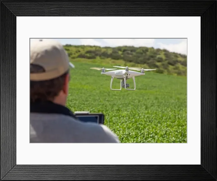 Framed Print : UAV Drone Pilot Flying and Gathering Data Over Country Farm Land Framed Print : UAV Drone Pilot Flying and Gathering Data Over Country Farm Land