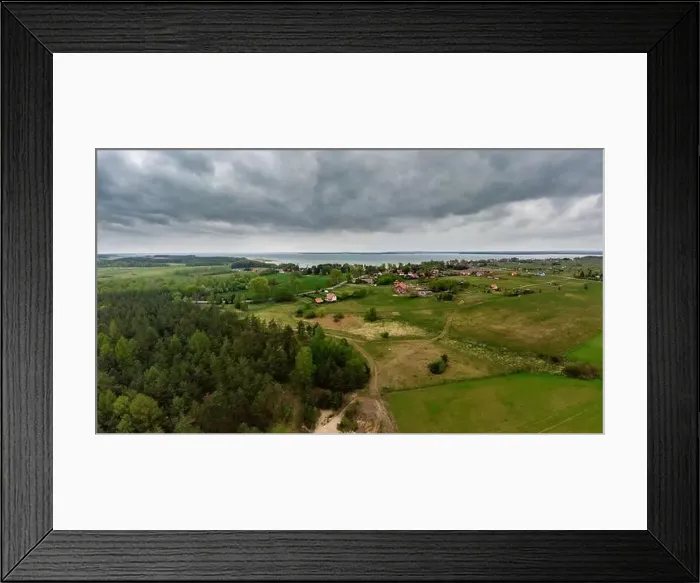 Framed Print : Aerial view of dark moody sky above Nowe Guty village and Sniardwy lake Framed Print : Aerial view of dark moody sky above Nowe Guty village and Sniardwy lake