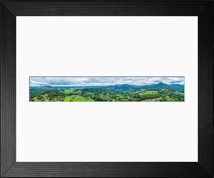 Framed Print : Ultra wide aerial panorama of scenic rural landscape with houses surrounded by trees, grasslands, and mountains Framed Print : Ultra wide aerial panorama of scenic rural landscape with houses surrounded by trees, grasslands, and mountains
