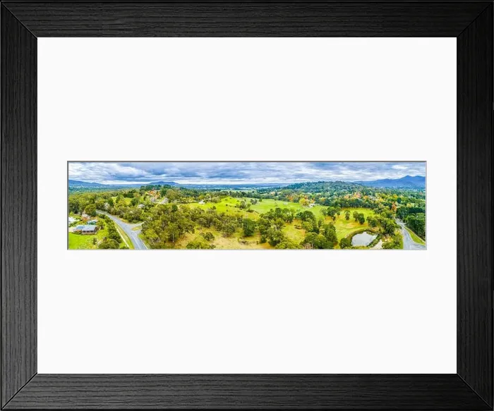 Framed Print : Wide aerial panoramic landscape of scenic countryside. Grasslands among trees and mountains in Australia Framed Print : Wide aerial panoramic landscape of scenic countryside. Grasslands among trees and mountains in Australia