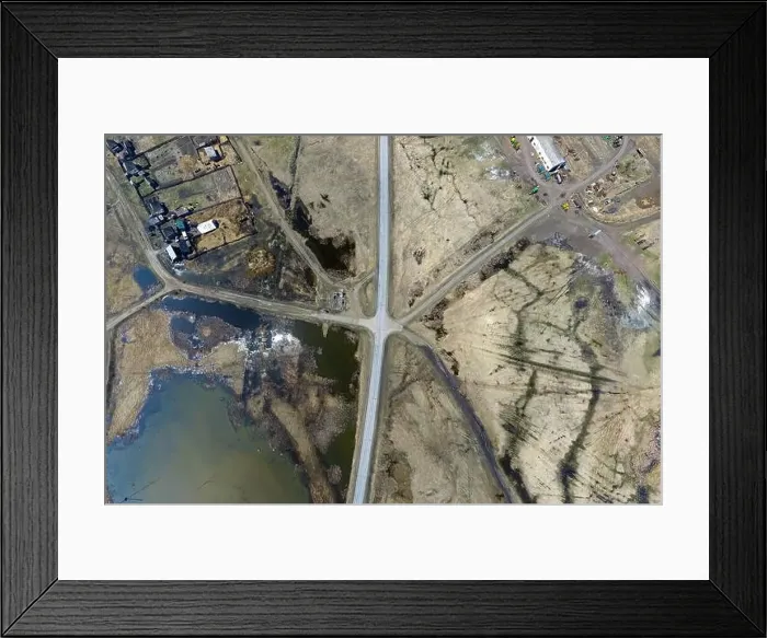 Framed Print : Aerial view of the intersection of asphalt and ground roads in the field far from the big cities on a clear spring day Framed Print : Aerial view of the intersection of asphalt and ground roads in the field far from the big cities on a clear spring day