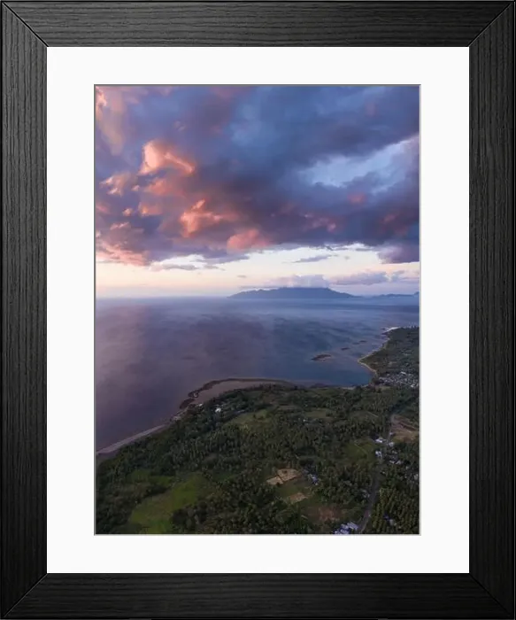 Framed Print : Seen from an aerial view, the tropical island of Flores is illuminated at sunset Framed Print : Seen from an aerial view, the tropical island of Flores is illuminated at sunset