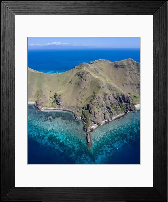 Framed Print : Seen from a bird's eye view, the blue Pacific Ocean surrounds the rugged island of Gili Banta Framed Print : Seen from a bird's eye view, the blue Pacific Ocean surrounds the rugged island of Gili Banta