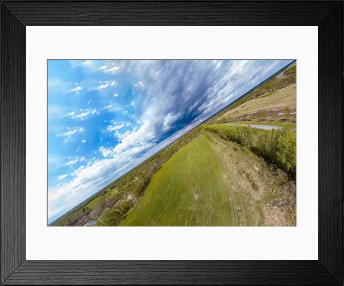 Framed Print : The frame is divided diagonally between a green meadow Framed Print : The frame is divided diagonally between a green meadow