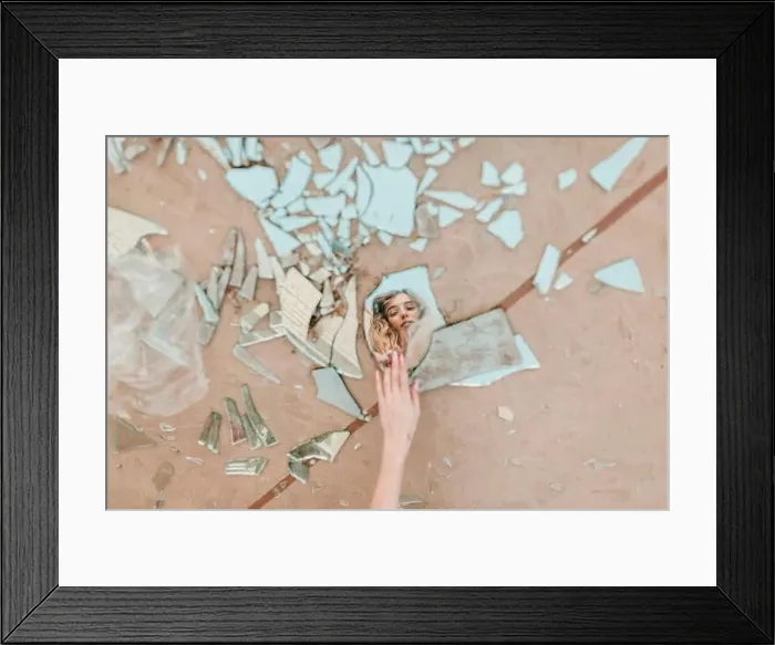Framed Print : Cropped hand of woman touching broken mirror pieces on footpath Framed Print : Cropped hand of woman touching broken mirror pieces on footpath