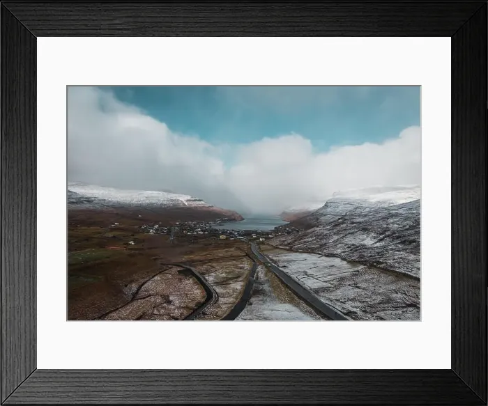 Framed Print : Aerial view of the village Sorvagur during a helicopter flight over the snow-covered landscape of the islands Vagar in Framed Print : Aerial view of the village Sorvagur during a helicopter flight over the snow-covered landscape of the islands Vagar in