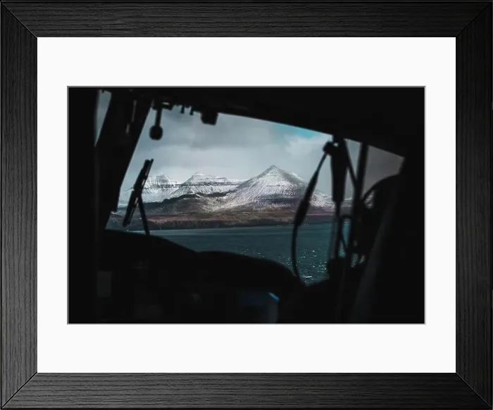 Framed Print : Aerial shot of snow-covered Faroese mountains taken from the inside of a helicopter during a flight over the Faroe Framed Print : Aerial shot of snow-covered Faroese mountains taken from the inside of a helicopter during a flight over the Faroe