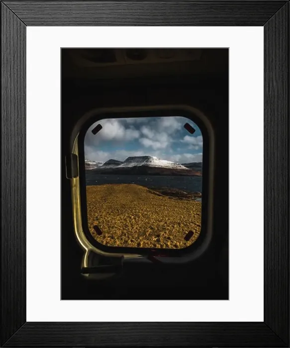 Framed Print : View onto the snow-covered shore of Faroese island Streymoy through a helicopter window taken on Koltur during an early Framed Print : View onto the snow-covered shore of Faroese island Streymoy through a helicopter window taken on Koltur during an early