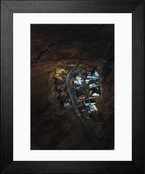 Framed Print : Faroese village as seen from above during a helicopter flight over the moody spring landscape of the Faroe Islands Framed Print : Faroese village as seen from above during a helicopter flight over the moody spring landscape of the Faroe Islands