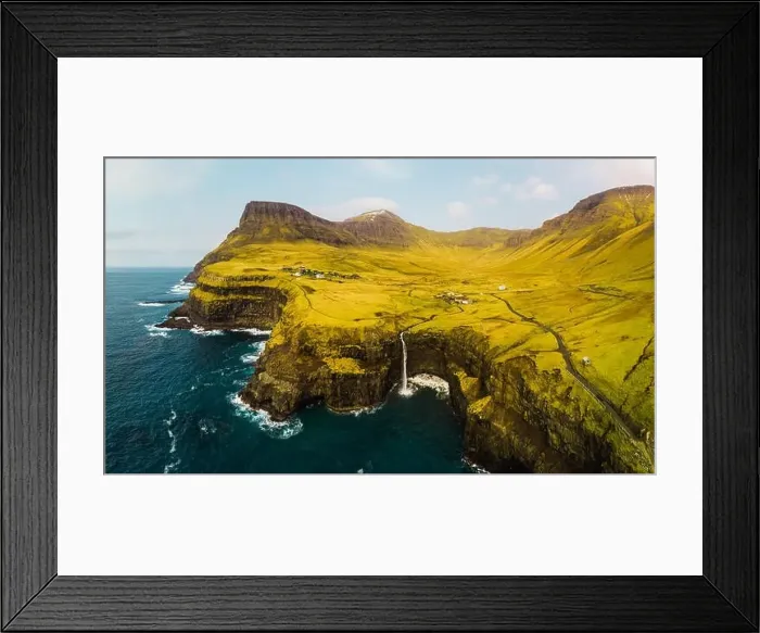 Framed Print : Aerial view of famous Gasadalur waterfall from above during a sunny spring day with snow-covered mountain peaks Framed Print : Aerial view of famous Gasadalur waterfall from above during a sunny spring day with snow-covered mountain peaks