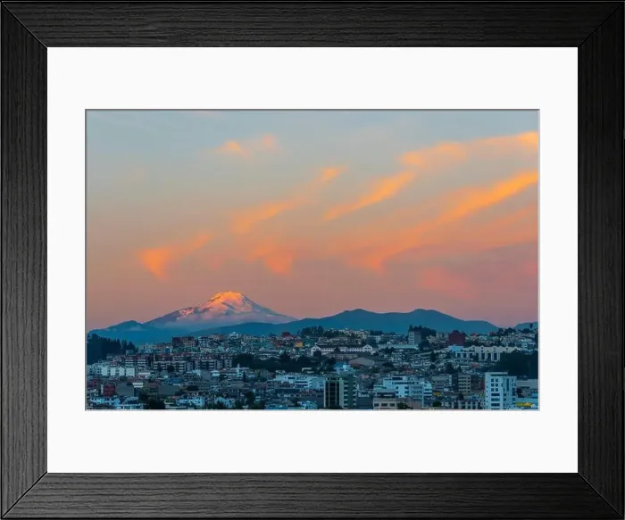 Framed Print : The majestic snowcapped Andes peak of the Cayambe volcano illuminated at sunset with the cityscape of Quito, Ecuador Framed Print : The majestic snowcapped Andes peak of the Cayambe volcano illuminated at sunset with the cityscape of Quito, Ecuador