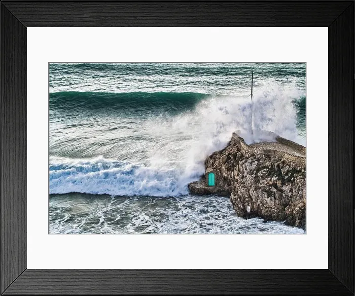 Framed Print : Crashing waves agains the rocks with a small green door Framed Print : Crashing waves agains the rocks with a small green door