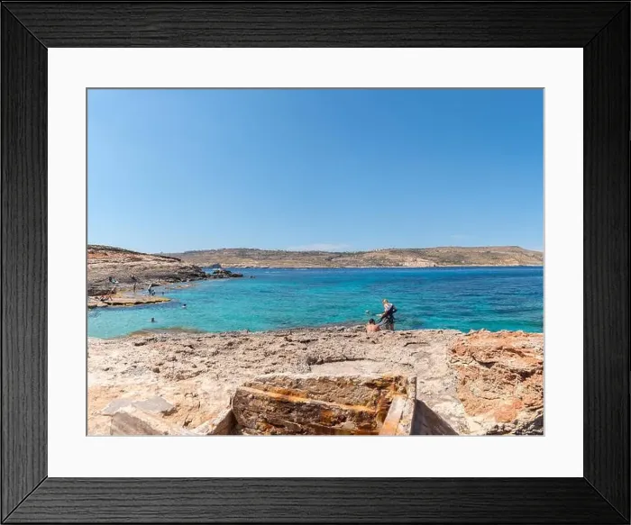 Framed Print : COMINO, MALTA - MAY 24, 2019 Holidays at Blue lagoon on island Comino, Malta Framed Print : COMINO, MALTA - MAY 24, 2019 Holidays at Blue lagoon on island Comino, Malta