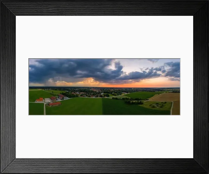 Framed Print : A drone shot of a sunset of a town, while rain clouds are coming Framed Print : A drone shot of a sunset of a town, while rain clouds are coming