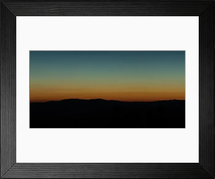 Framed Print : Wide angle panorama silhouette mountain tops in orange blue gradient sunset