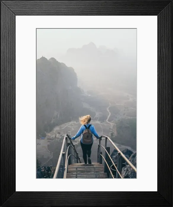 Framed Print : Woman in denim shirt standing on mountain peak with stairs going down during sunrise foggy morning in Hpa-An, Myanmar Framed Print : Woman in denim shirt standing on mountain peak with stairs going down during sunrise foggy morning in Hpa-An, Myanmar