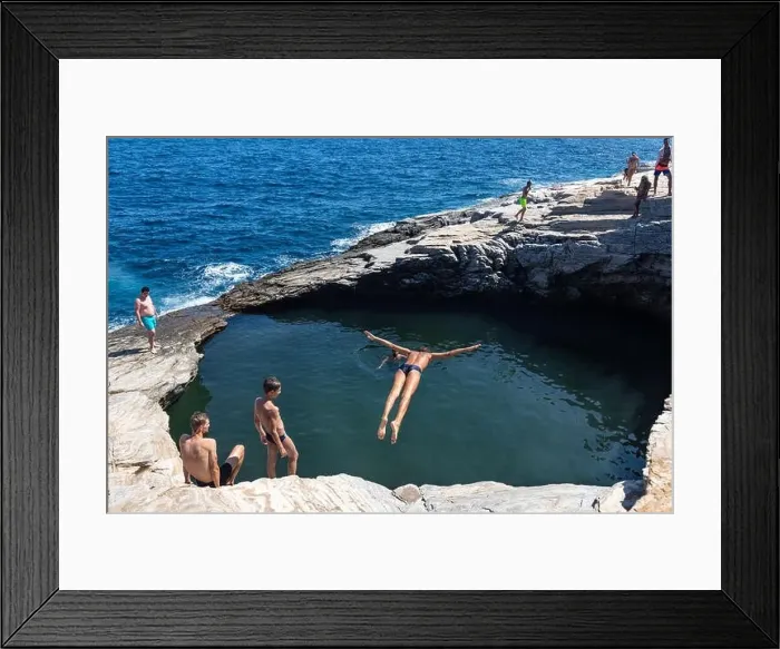Framed Print : Thassos, Greece - July 20, 2019: Tourists are doing diving in the natural swimming pool Giola in Thassos island, Greece Framed Print : Thassos, Greece - July 20, 2019: Tourists are doing diving in the natural swimming pool Giola in Thassos island, Greece