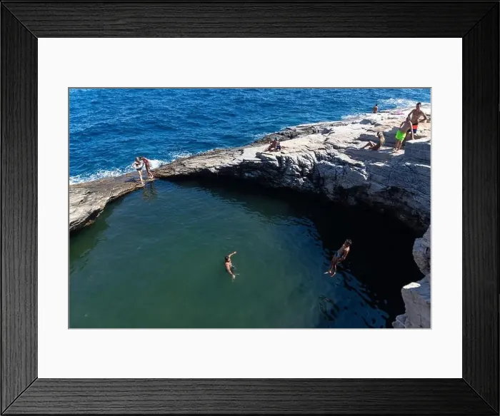 Framed Print : Thassos, Greece - July 20, 2019: Tourists are doing diving in the natural swimming pool Giola in Thassos island, Greece Framed Print : Thassos, Greece - July 20, 2019: Tourists are doing diving in the natural swimming pool Giola in Thassos island, Greece