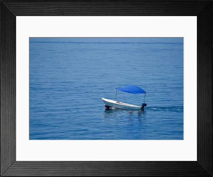 Framed Print : Empty little boat with a blue top on the sea Framed Print : Empty little boat with a blue top on the sea