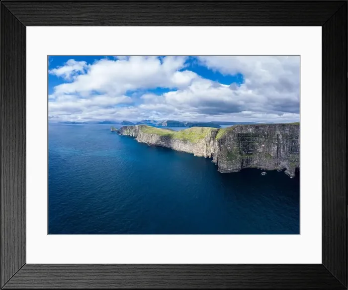 Framed Print : Panoramic aerial view from Sandoy island cliffs and rock stacks under the clouds, Faroe Islands Framed Print : Panoramic aerial view from Sandoy island cliffs and rock stacks under the clouds, Faroe Islands