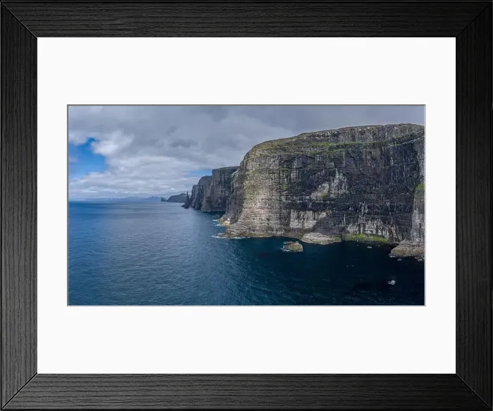 Framed Print : Panoramic aerial view from Sandoy island cliffs and rock stacks under the clouds, Faroe Islands Framed Print : Panoramic aerial view from Sandoy island cliffs and rock stacks under the clouds, Faroe Islands