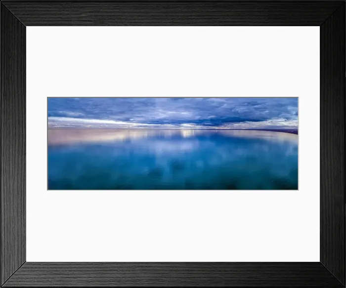 Framed Print : Wide aerial panorama of stormy clouds over smooth ocean water surface Framed Print : Wide aerial panorama of stormy clouds over smooth ocean water surface