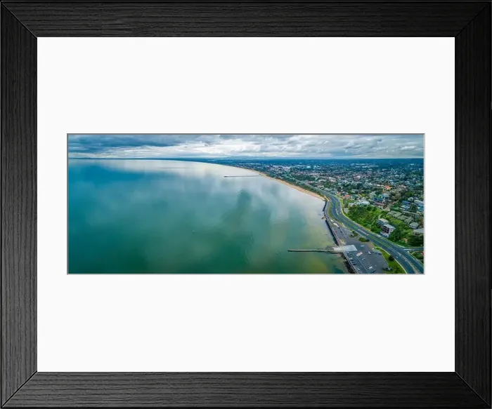 Framed Print : Scenic Mornington Peninsula coastline along Frankston suburb showing two piers on overcast day - aerial panoramic Framed Print : Scenic Mornington Peninsula coastline along Frankston suburb showing two piers on overcast day - aerial panoramic